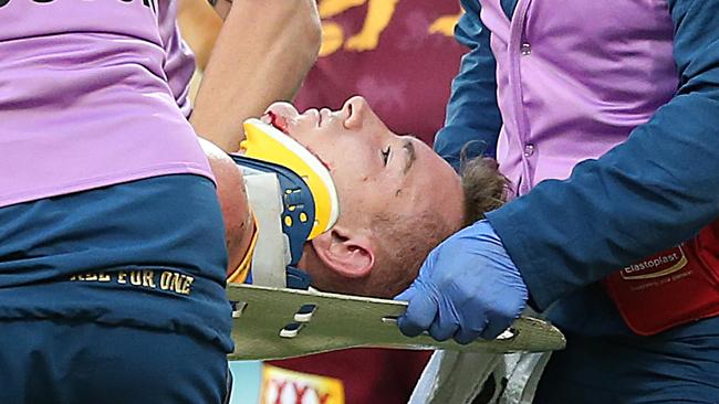 Harris Andrews is helped off the ground. Picture: Getty Images