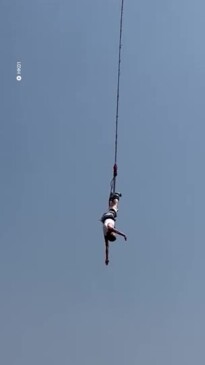 Moment tourist's bungee rope snaps, sending him plummeting into the water  below and knocking him out