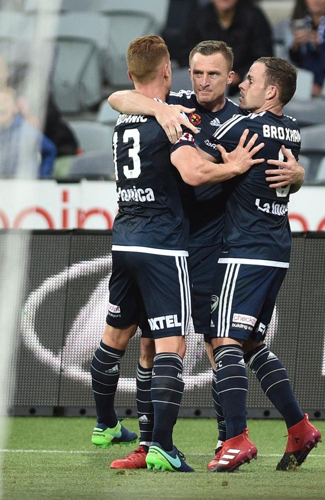 Oliver Bozanic and Leigh Broxham rush to Berisha. Picture: AAP