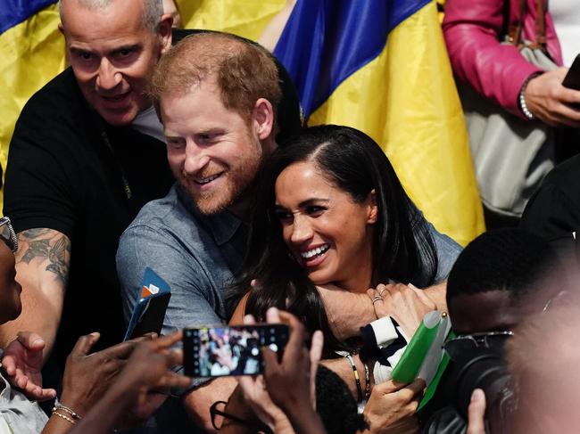 Harry had his arms wrapped around his wife during an event on Thursday. Picture: Jordan Pettitt/PA Images via Getty Images)