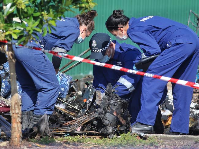 Forensic officers investigate the fire. Picture: Hamish Blair