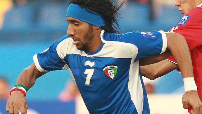 DOHA, QATAR - JANUARY 08: Fahad Al Enezi of Kuwait is challenged by Yu Hai of China the AFC Asian Cup Group A match between China PR and Kuwait at AL Gharafa Stadium on January 8, 2011 in Doha, Qatar. (Photo by Robert Cianflone/Getty Images)