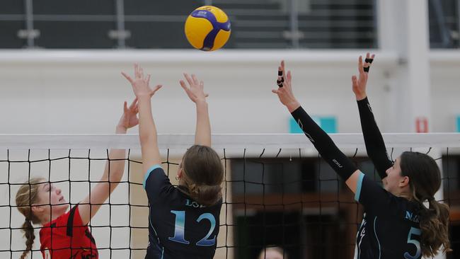 Lauren Brasell and Lara Maric of Elite Black block a shot from Lilyana Stanojevic (left) of Dragons during the Under-19 girls Volleyball Queensland Junior State Championships final in 2023. Photo: Regi Varghese