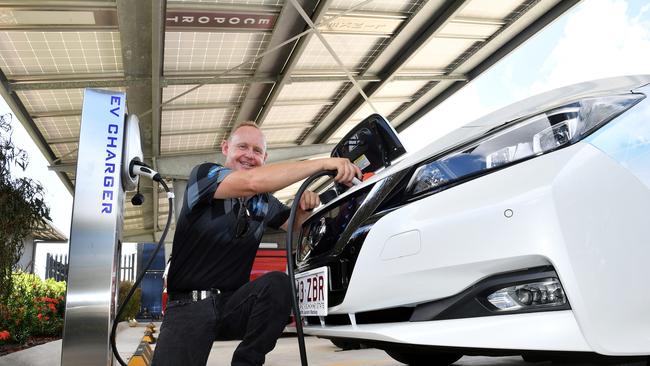 Linked Group Services managing director Jason Sharam using a car charging station. Picture: Tony Martin