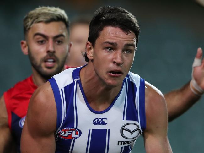 ADELAIDE, AUSTRALIA - AUGUST 09: Luke Davies-Uniacke of the Kangaroos chased by Christian Salem of the Demons during the 2020 AFL Round 11 match between the Melbourne Demons and the North Melbourne Kangaroos at Adelaide Oval on August 09, 2020 in Adelaide, Australia. (Photo by Matt Turner/AFL Photos)