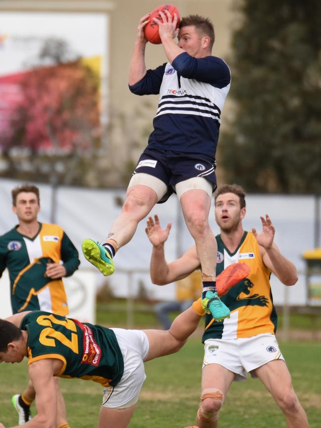 Gary Moorcroft takes a hanger over Northcote Park's Marty Hore. Picture: Nathan McNeill