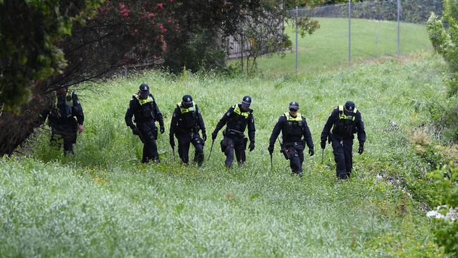 Police combed the area near where the dumped SUV was found. Julian Smith/AAP.