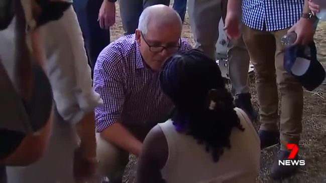 Woman falls to her knees at Prime Minister's feet begging for help