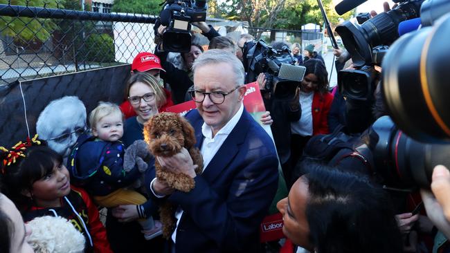 Anthony Albanese with his dog on election day, 2021. On his stage three tax cut pledge, Australians were sold a pup.