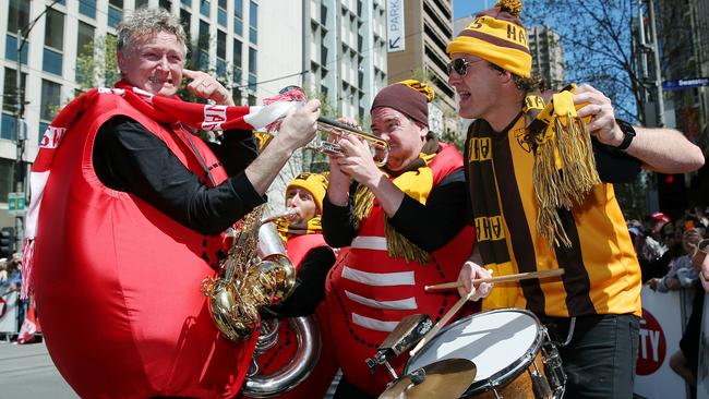 The crowd entertainment got stuck into each other at the 2014 AFL Grand Final Parade. Picture: Colleen Petch.