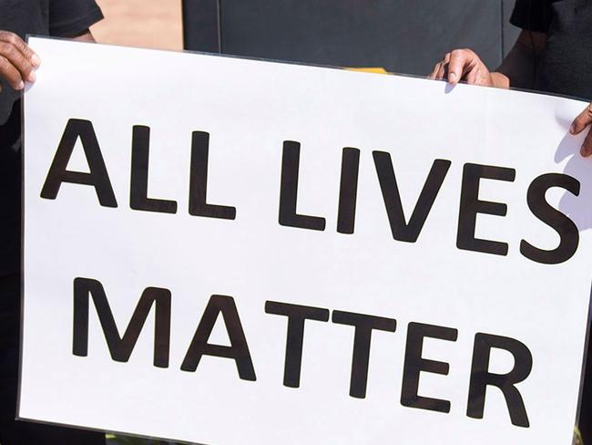 Protesters hold a banner  during a demonstration by South African farmers & farm workers  at the Green Point stadium to protest against farmer murders in the country, on October 30, 2017, in Cape Town. Thousands of white farmers blocked roads in South Africa on October 30 to protest against what they say is an explosion of violence against their communities in rural areas. Large demonstrations under the "Black Monday" banner were held in Cape Town, Johannesburg and the capital Pretoria. Marchers dressed in black to commemorate the victims of hundreds of deadly "farm attacks" in recent years. / AFP PHOTO / DAVID HARRISON