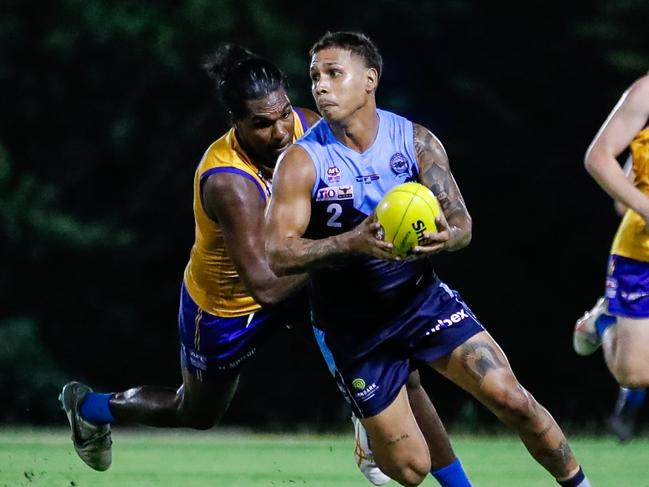 Nick Yarran of the Darwin Buffaloes escapes Wanderers' captain Mitchel Taylor in Round 16 of the 2023-24 NTFL season. Picture: Celina Whan / AFLNT Media