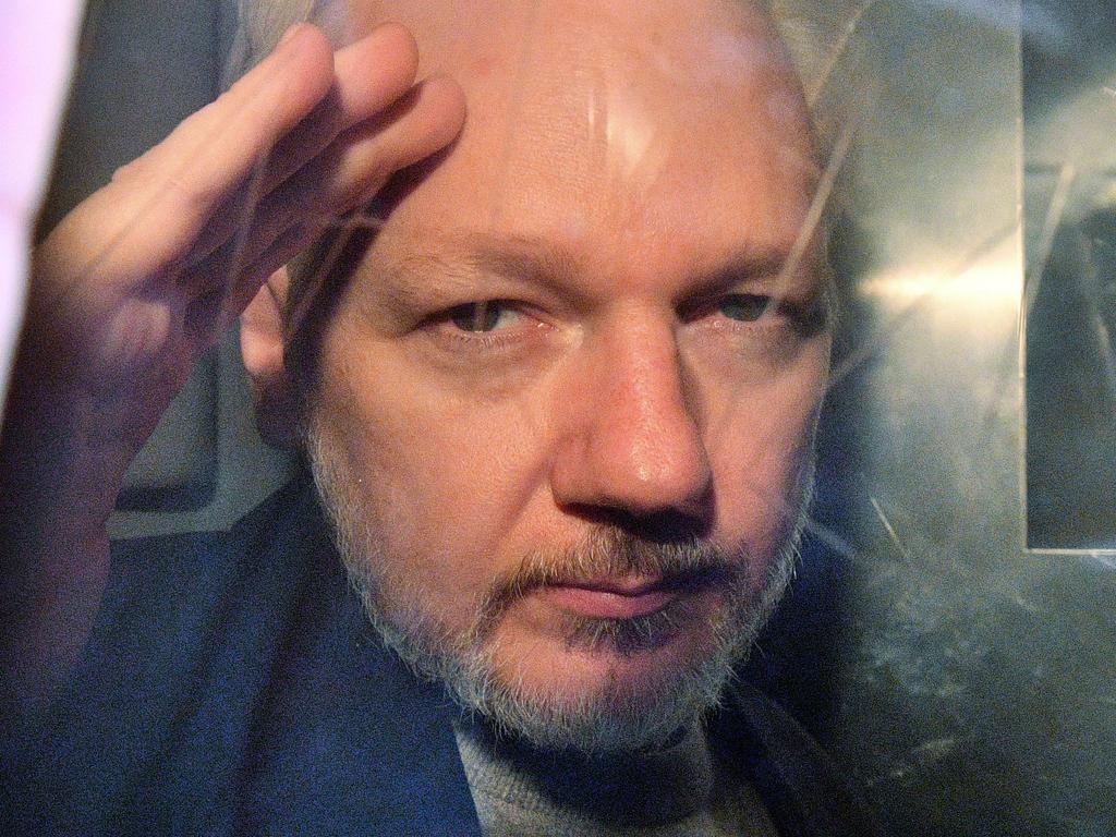 WikiLeaks founder Julian Assange gestures from the window of a prison van last year after being sentenced to 50 weeks in prison for breaching his bail conditions in 2012. Picture: Daniel Leal-Olivas/AFP