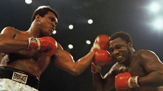 Boxers Muhammad Ali (L) and Joe Frazier fight in a 12-round non-title fight at Madison Square Garden in New York in 1974.