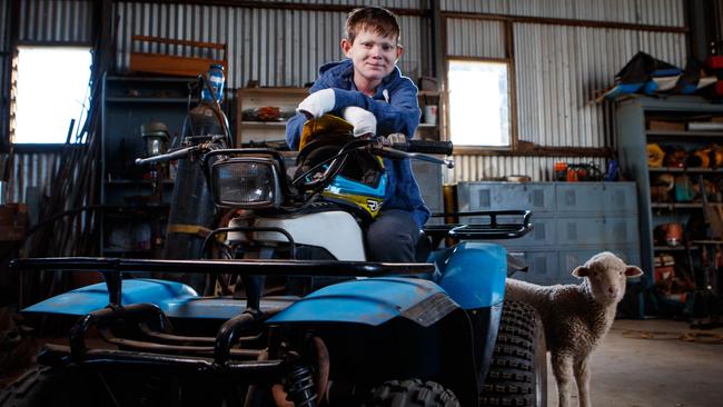 John Hutchins in the shed with Ron the pet lamb. Picture Matt Turner.