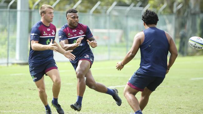 Samu Kerevi, centre, gets ready to catch the ball at Reds training at Ballymore yesterday. Picture: Mark Cranitch