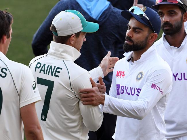 India's captain Virat Kohli congratulates Australian skipper Tim Paine after the stunning first-Test result. Picture: AFP