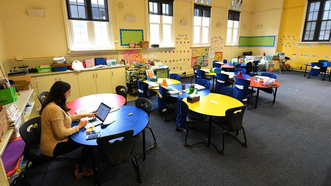 A teacher works in an empty classroom at a Melbourne primary school in March. Picture: AAP