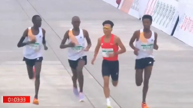 Organizers of Beijing half marathon investigating claims that three African athletes allowed China?s star runner, He Jie, to win the race (video)