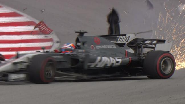 Romain Grosjean crashes after a loose drain cover punctures his tyre.