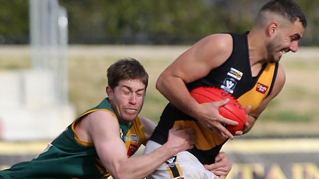 Springbank’s James Thompson gets tackled during last year’s grand final. Picture Yuri Kouzmin