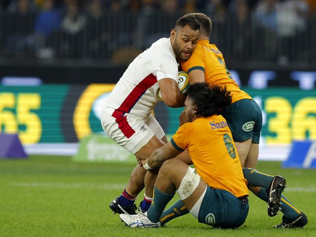 Billy Vunipola is gang tackled by a couple of Wallabies in the first Test.