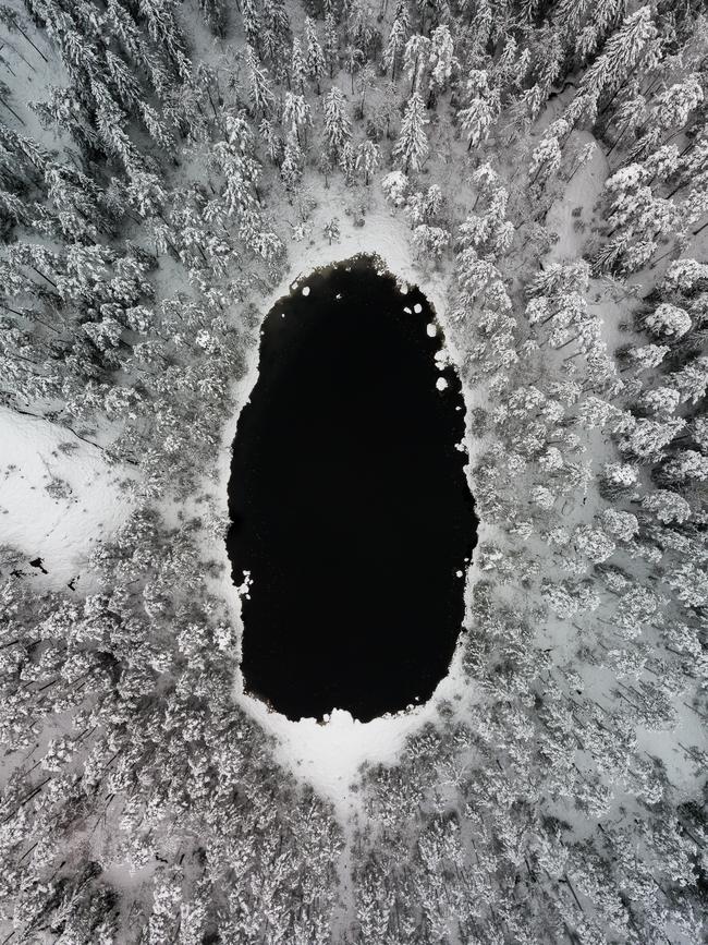 Image Name: Black hole Photographer Name: Damon Beckford Year: 2018 Image Description: A small pond and snow covered trees in Nuuksio National park, Finland. When the first snow came to Southern Finland, I headed to a national park near where I live and took my drone with me so I could capture some unique perspectives. Shot in November 2017. Copyright: Damon Beckford, Winner, Finland National Award. Picture: Sony World Photography Awards/ Damon Beckford