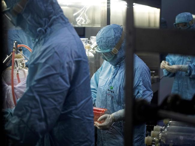 Researchers in protective suits work in a lab at the Yisheng Biopharma company, where researchers are trying to develop a vaccine for the COVID-19 coronavirus, in Shenyang, in Chinaâs northeast Liaoning province, on June 9, 2020. - China has mobilised its army and fast-tracked tests in the global race to find a coronavirus vaccine, and is involved in several of the dozen or so international clinical trials currently under way. (Photo by NOEL CELIS / AFP)