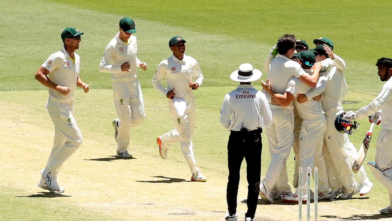 Australian players celebrate victory over India in Perth.