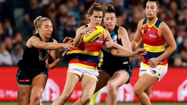 Chelsea Randall attempts to get her kick away before being tackled. Picture: James Elsby/AFL Photos via Getty Images