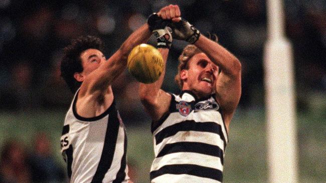 Andrew Schauble makes the spoil against Geelong superstar Gary Ablett Snr back in 1995.