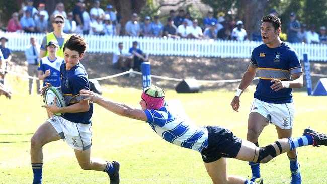 Churchie player Luke Philp tries to break free of Nudgee last season. (AAP image, John Gass)