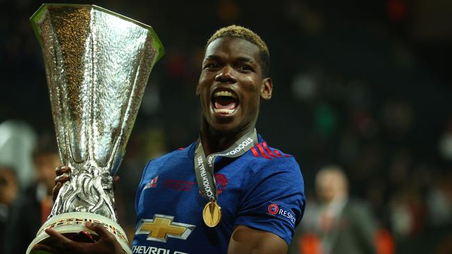 Manchester United's French midfielder Paul Pogba celebrates with the Europa League trophy