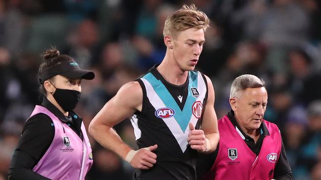 Todd Marshall is taken from the field under the concussion rule. Picture: AFL Photos via Getty Images