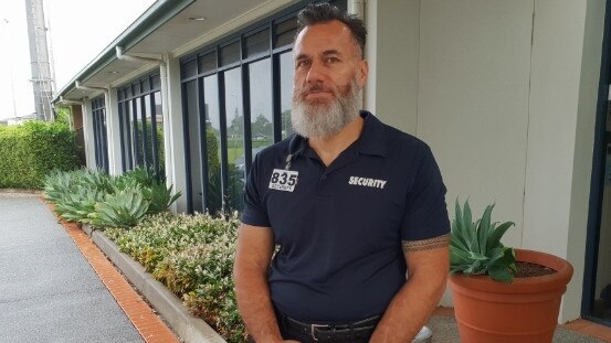 The security guard outside of the Italo-Australian Club before the meeting.