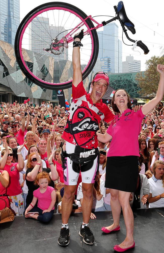 Samuel and Connie Johnson celebrate after he arrives back in Melbourne after a year riding around Australia on a unicycle in aid of breast cancer research. Picture: Mark Stewart