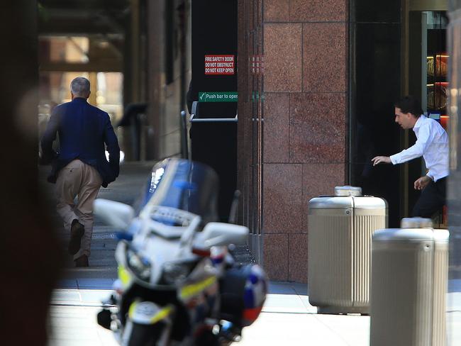 Two of the hostages run from the Lindt cafe yesterday. Picture: Toby Zerna