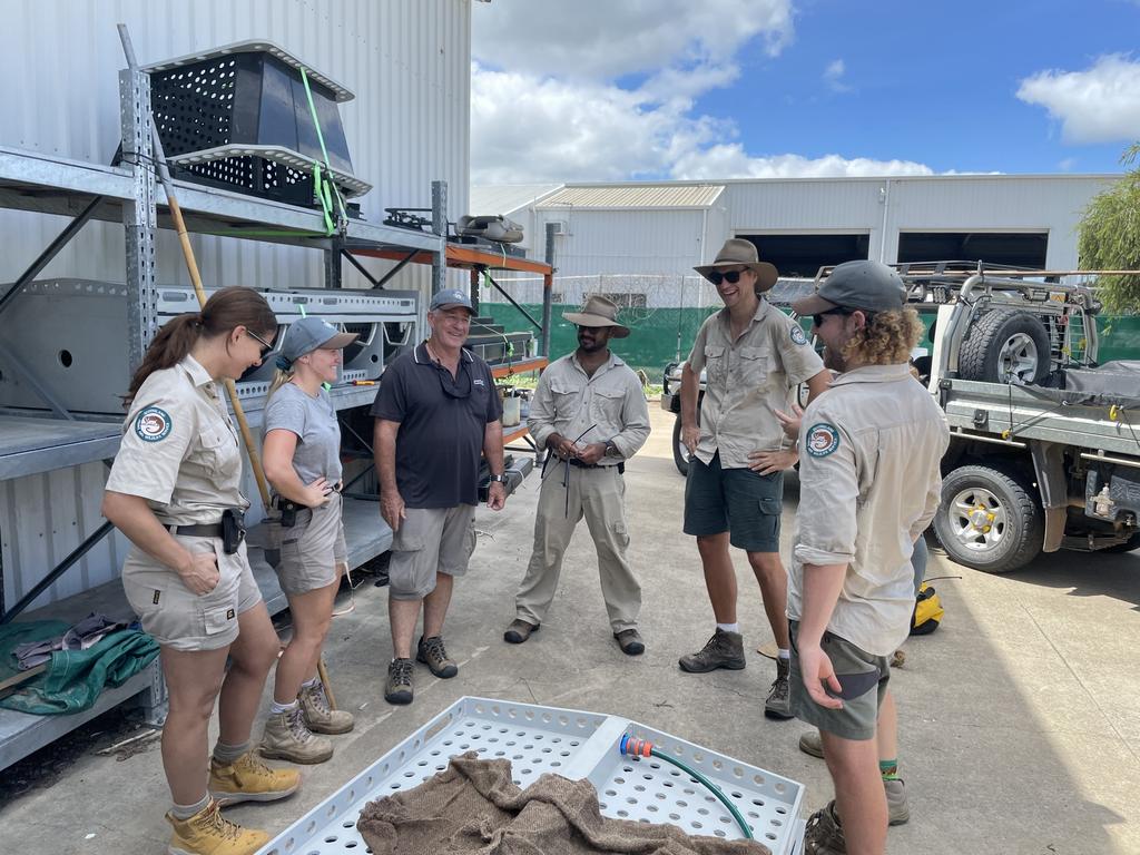 Queensland Department of Environment and Science and Queensland Parks and Wildlife Service officers debrief after the captured croc was released into a holding pond. Picture: Leighton Smith.