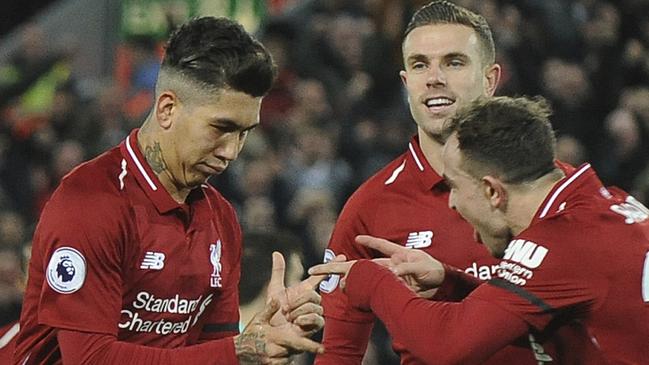 Liverpool's Roberto Firmino, left, celebrates with teammates after he scores his sides 5th goal and his 3rd from the penalty spot during the English Premier League soccer match between Liverpool and Arsenal at Anfield in Liverpool, England, Saturday, Dec. 29, 2018. (AP Photo/Rui Vieira)