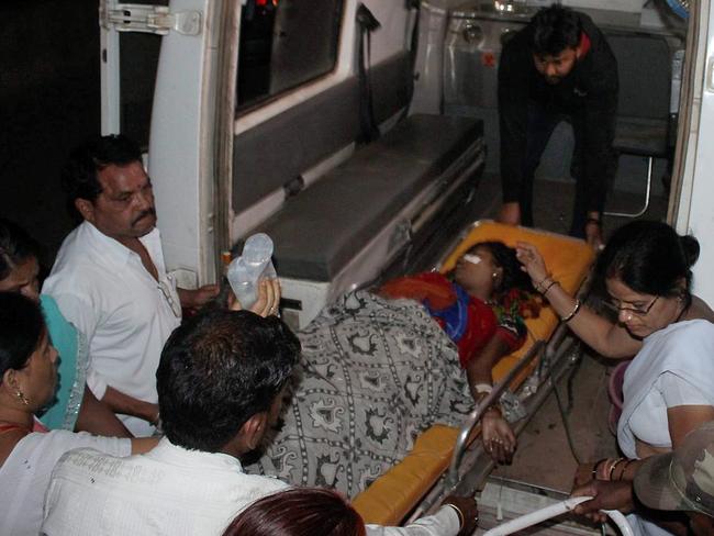 An Indian woman who underwent sterilisation surgery is carried on a stretcher for treatment at the CIMS hospital in Bilaspur.