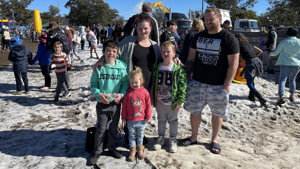 Darcy (7), Eleanor (3), Natasha, Jacob (10) and Kyle O'Brien from Ipswich brave the muddy conditions to get to the snowfields at the 2021 Snowflakes in Stanthorpe festival. Photo: Madison Mifsud-Ure / Stanthorpe Border Post