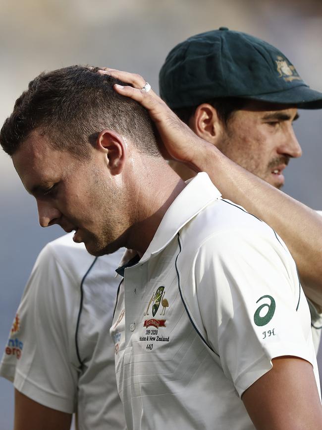 Josh Hazlewood is consoled by Mitchell Starc after leaving the field on day two of the first Test. Picture: Getty