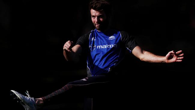 Luke McDonald kicks during a light training run. Picture: Michael Klein