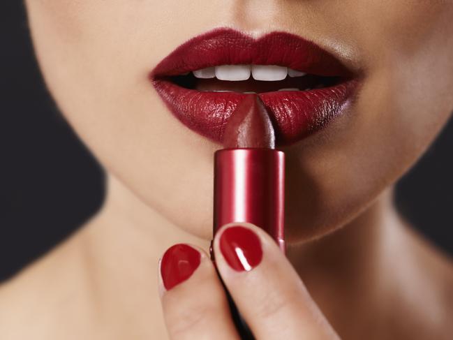 MONEYSAVER HQ KOCH:  Closeup image of a woman applying lipstick Picture: iStock