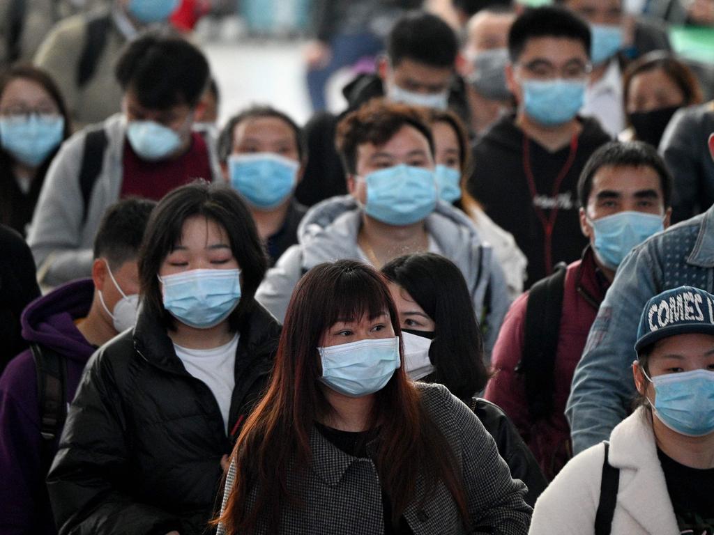 Passengers wearing face masks arrive at Changsha railway station in Changsha, the capital of Hunan province on March 8, 2020. Picture: Noel Celis/AFP