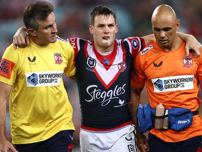 SYDNEY, AUSTRALIA - MARCH 26:  Luke Keary of the Roosters is helped off the field after a leg injury during the round three NRL match between the South Sydney Rabbitohs and the Sydney Roosters at Stadium Australia on March 26, 2021, in Sydney, Australia. (Photo by Cameron Spencer/Getty Images)