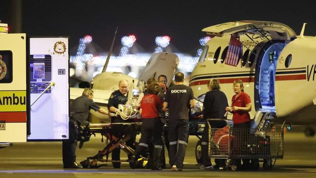 One of five coalminers who suffered terrible burns in the explosion arrives at the Royal Flying Doctor Service base in Brisbane on Wednesday night. Picture: AAP