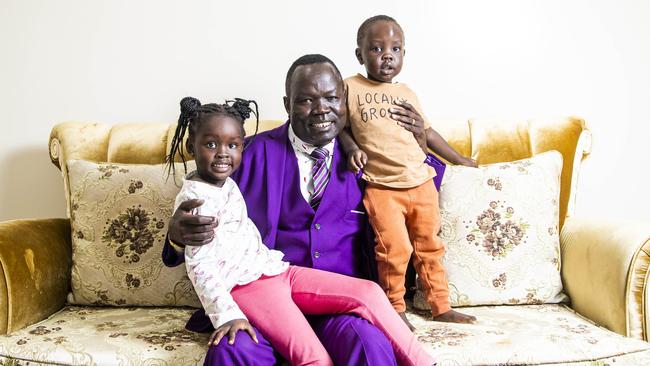 Ambrose Mareng, with daughter About Mayar, 4, and son Nihiah Mayar, 2, is forced to translate crucial government vaccine information for his South Sudanese community. Picture: Aaron Francis