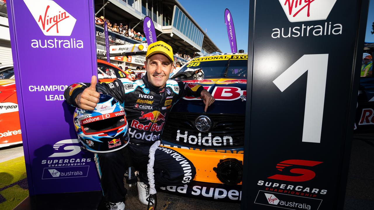 Jamie Whincup points to the Holden badge on his car after winning Race 1.