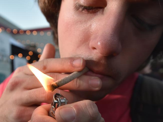 (FILES) In this file photo a man lights a joint at the annual DOPE Cup, a cannabis competition in Portland, Oregon, on October 4, 2015. - Oregon on November 3, 2020 became the first US state to decriminalize hard drugs, including the possession of small amounts of heroin and cocaine, and to legalize access to "magic mushrooms" for therapeutic use. Some other states, including Arizona and Montana, meanwhile appeared poised in early results to legalize recreational marijuana in line with a trend sweeping the country in recent years. (Photo by Josh Edelson / AFP)